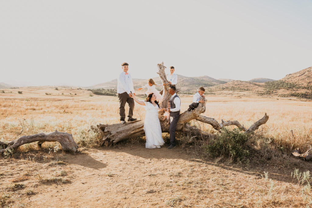 A couple and their five children in the Wichita mountains on their elopement day stand together. 