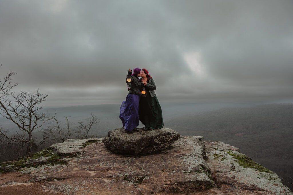 A couple is standing on White Rock Mountain, one of the best places to elope in Arkansas!