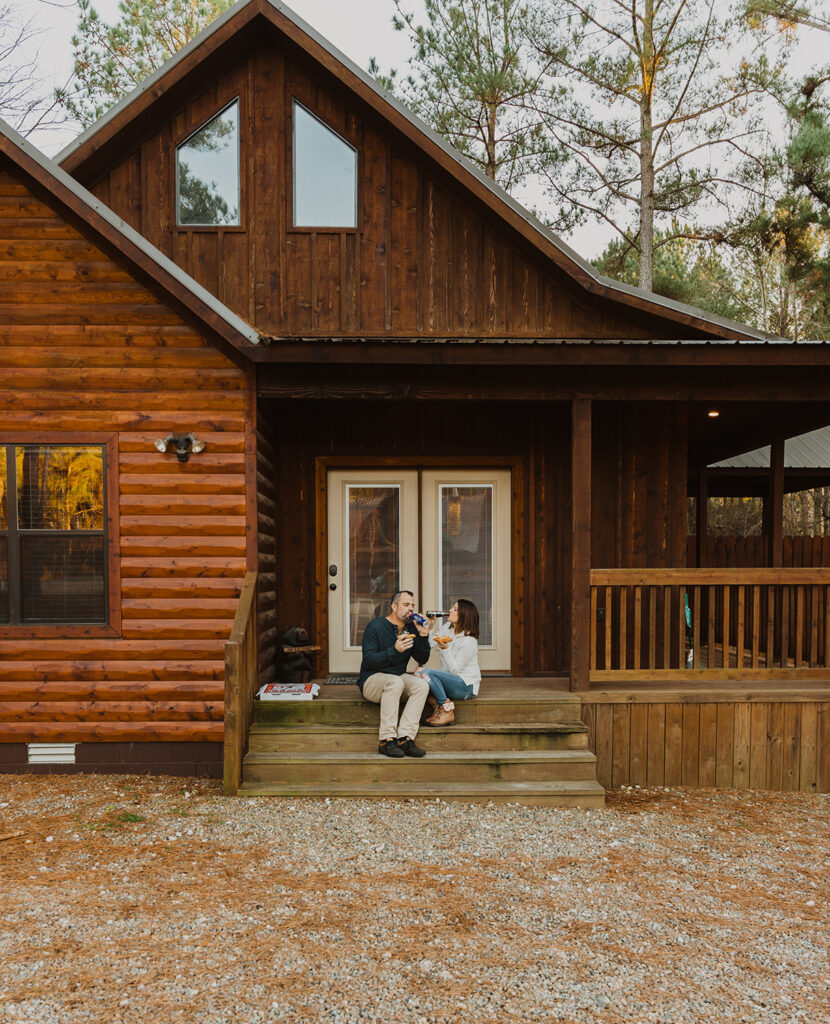 A couple sitting on the steps of a cabin in Oklahoma, preparing for their elopement day.