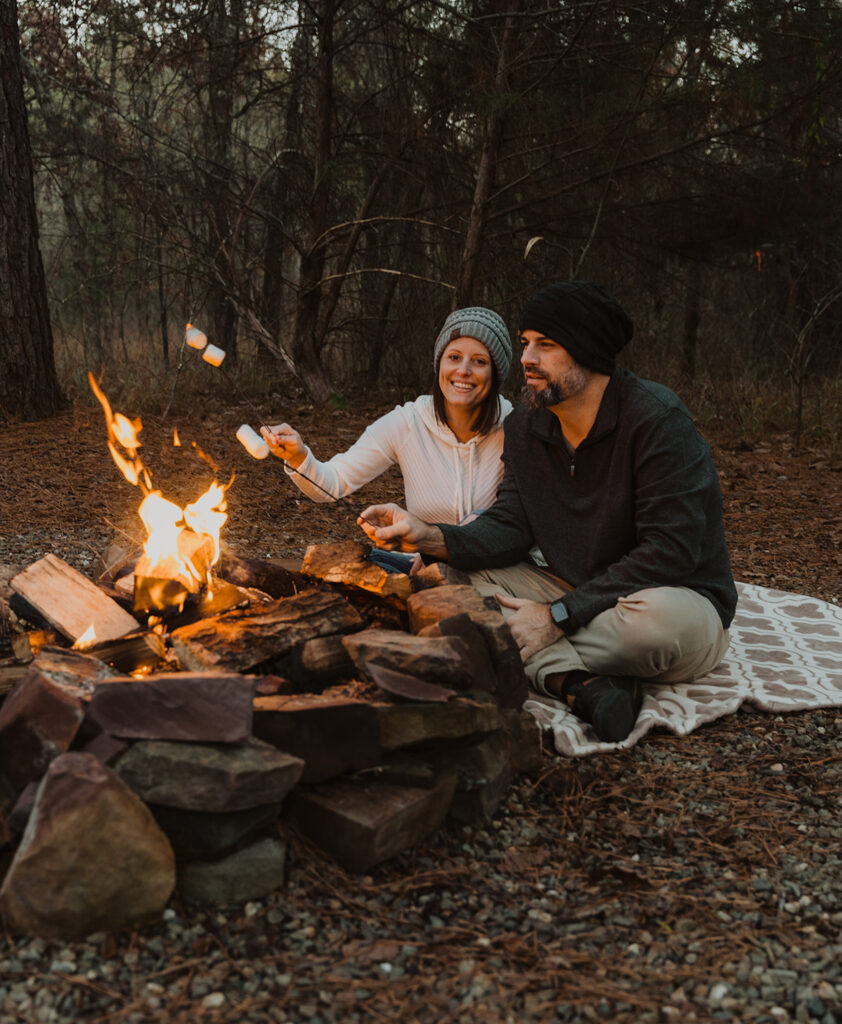 A couple roasts marshmallows together after their elopement in Broken Bow, Oklahoma. 