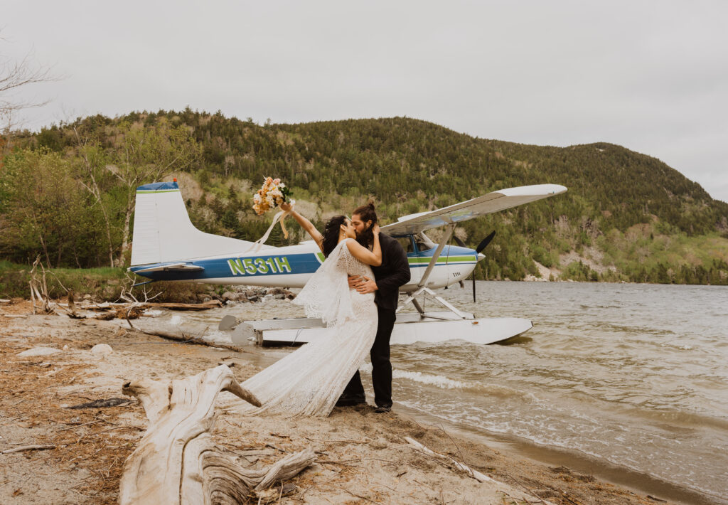 A couple eloping in front of a sea plane at Acadia national park