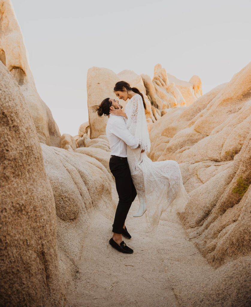 A couple in a slot canyon on their elopement day in Joshua Tree national park. One of the best places to elope in.
