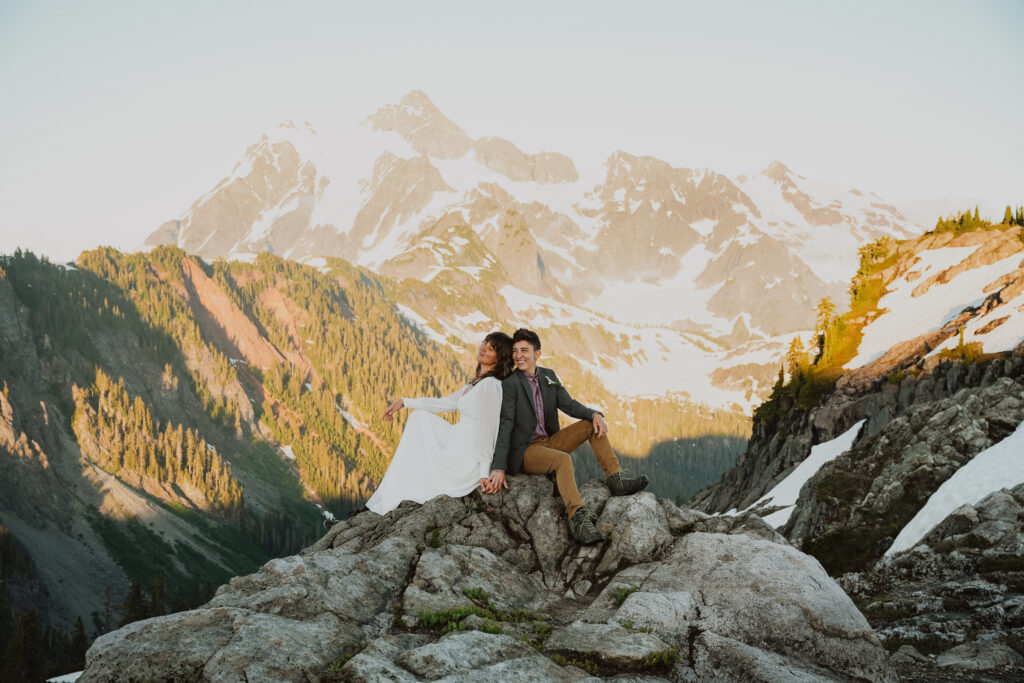 A lgbtq eloping couple pose in mt rainier national park on their wedding day. 