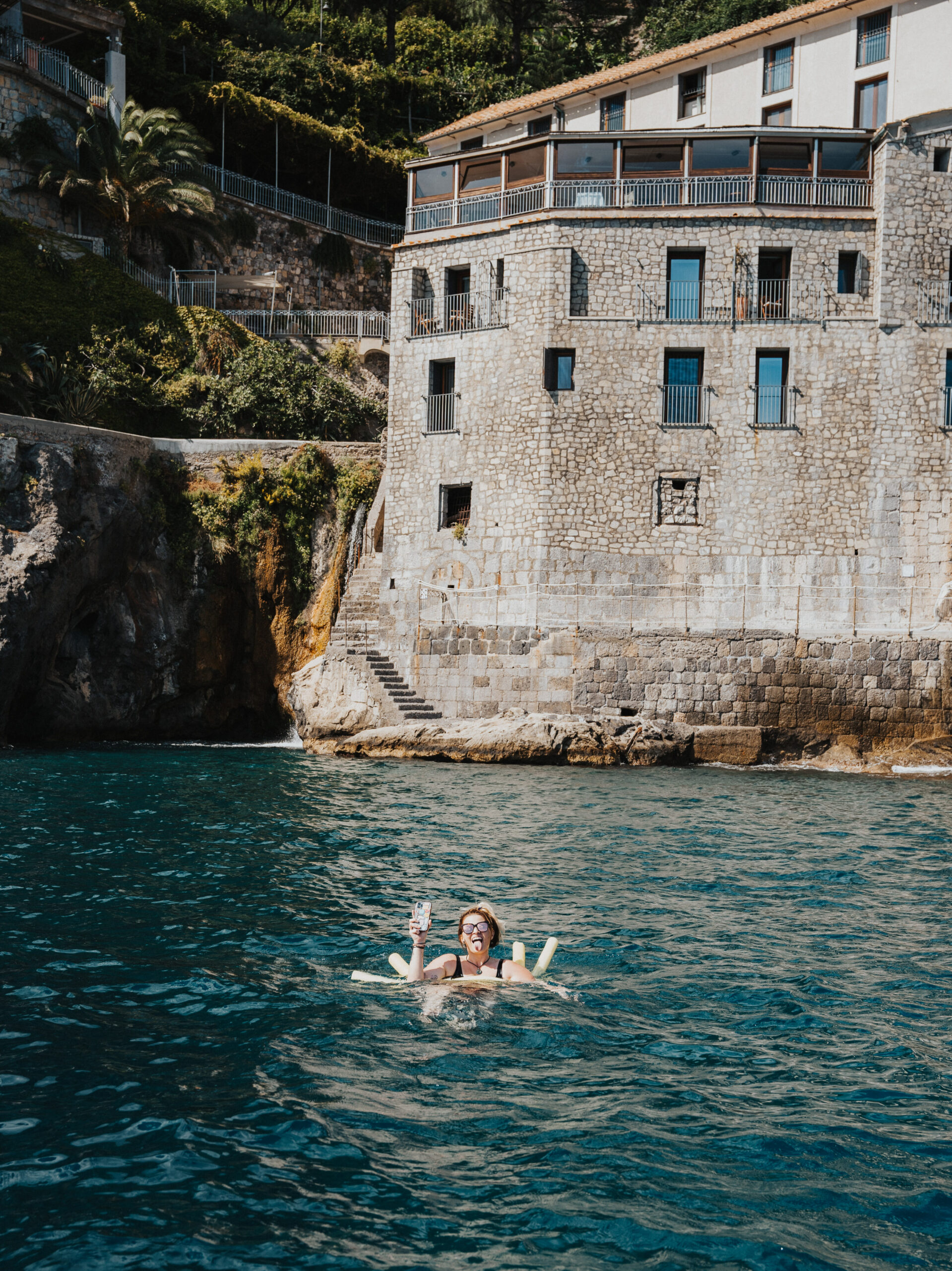 Swimming in the ocean near Positano, Italy for LGBTQIA+ elopement. 