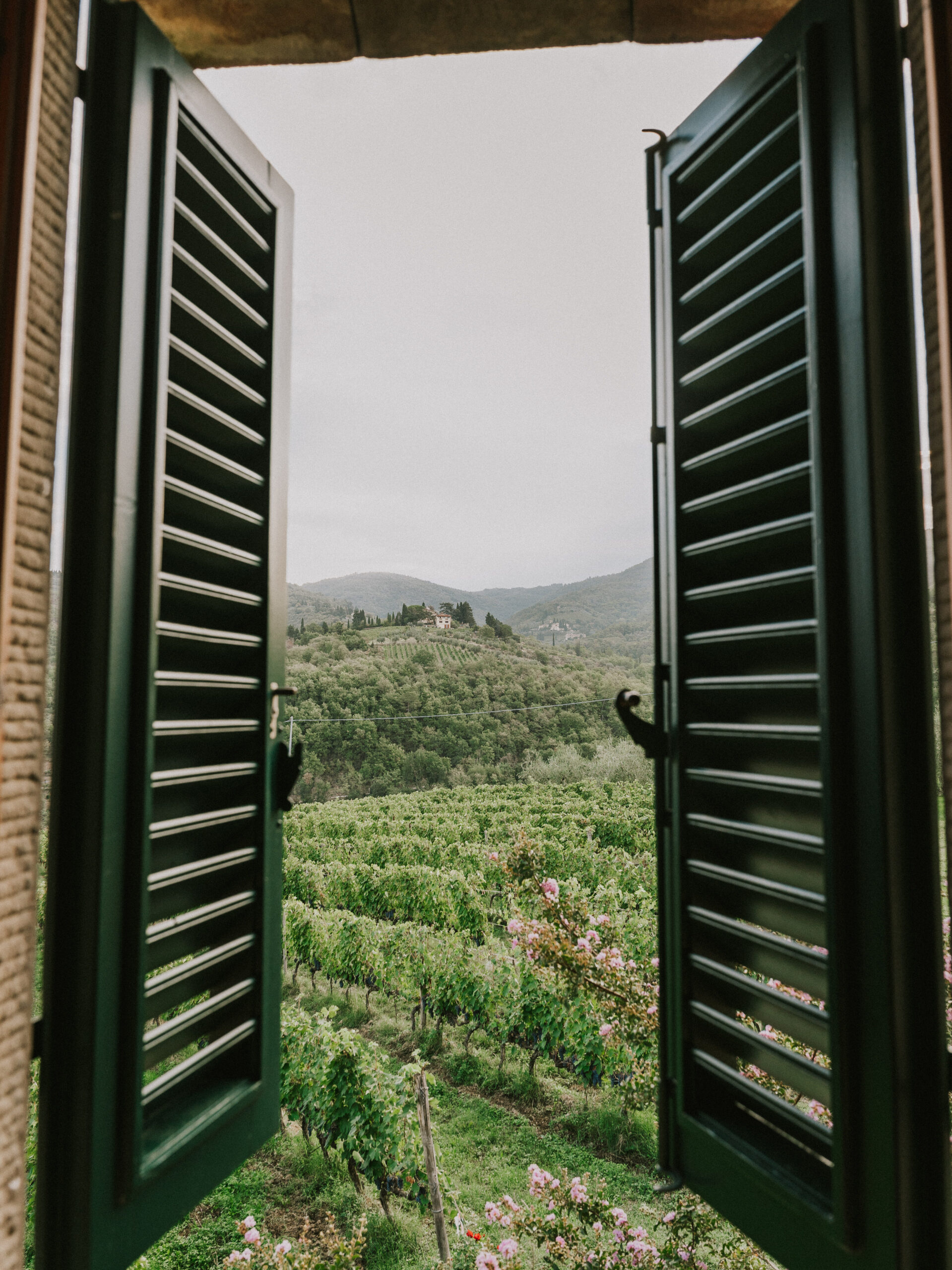 Rolling hills of Tuscany through shutter windows, Italy. 