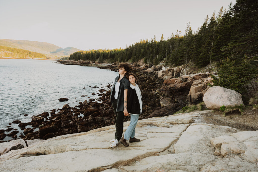 a lgbtq couple holding hands in acadia national park